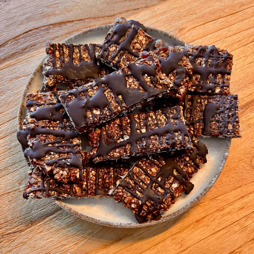 Delicious homemade chocolate protein bars made with oats, dates, peanut butter, protein powder, almonds, and dark chocolate for a healthy snack.